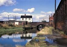 BCN Main Line. Biddings Lane Bridge. 14/09/1970 [Cannon Factory alongside Towpath]