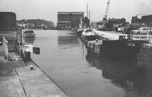 Hire boat approaching Gloucester Lock from the docks. 1980