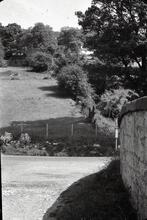 Road over canal bridge looking towards road junction with bus stop