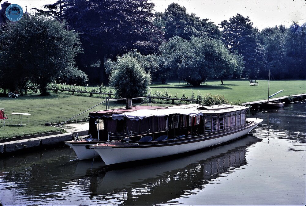 Elegant River Launches moored at large private garden