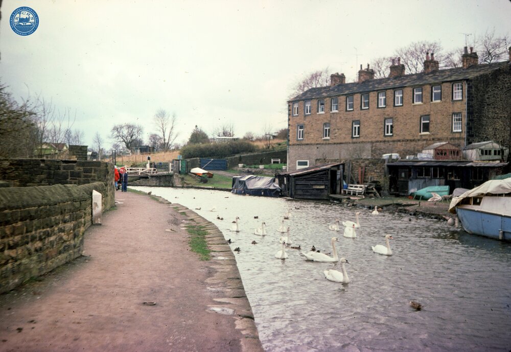 Leeds & Liverpool Canal. Skipton. Cottages, swans and milestone against wall. 1977