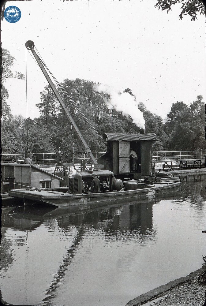 River Thames. Above Bell Weir Lock. Steam crane pile driving. 1959 