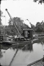 River Thames. Above Bell Weir Lock. Steam crane pile driving. 1959 