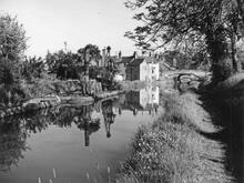 Gnosall:  A dredger is tied up at the site of the former village wharf (1957)  