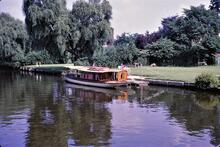 Elegant River Launches moored at large private garden