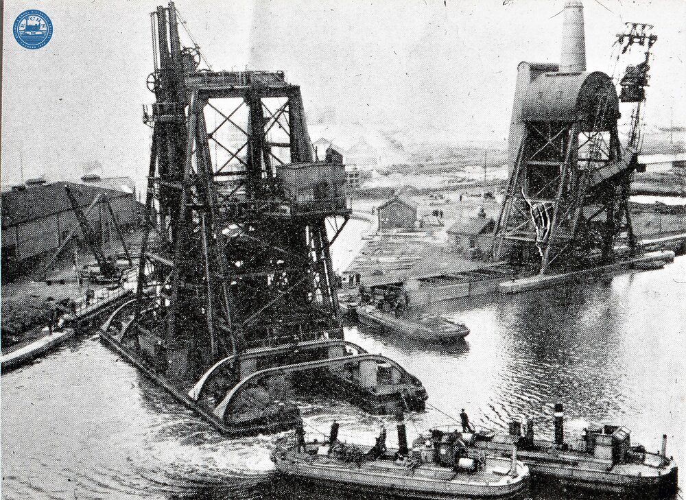 Aire & Calder Navigaton. Two steam tugs towing No 4 compartment boat floating hoist at Goole. Built 1908