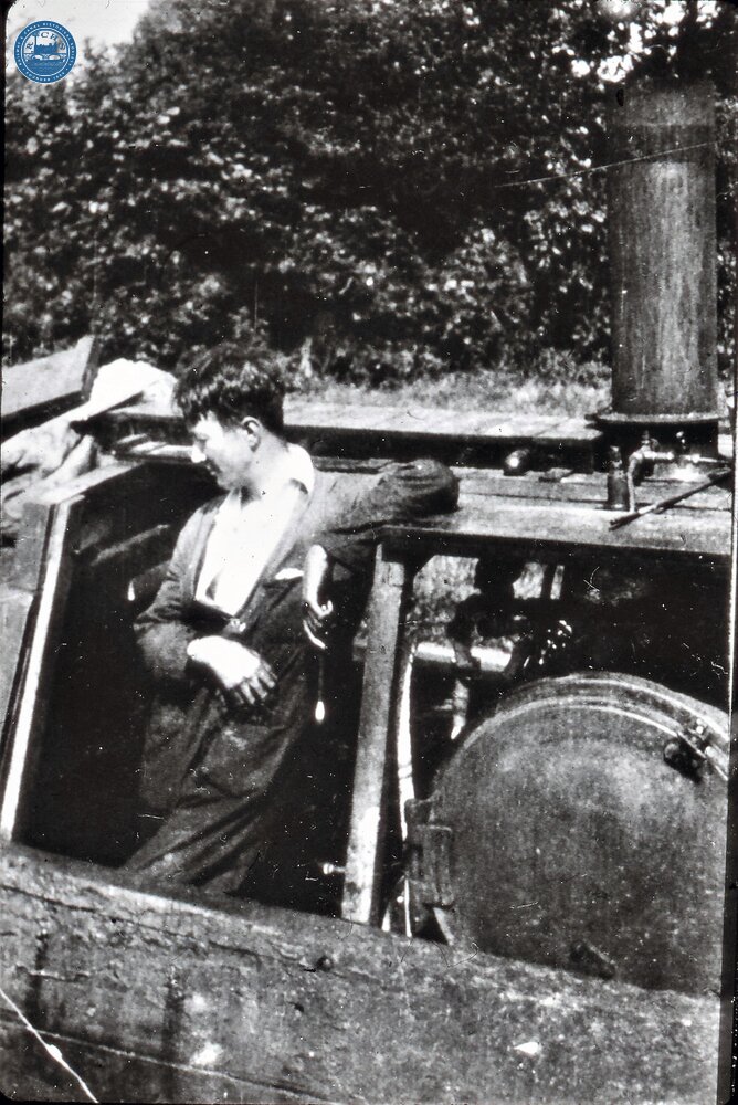 Tom Rolt standing in engine room hatch aboard "Cressy" when a steamer. c.1930 at Welsh Frankton on trial run. Plenty engine; Yorkshire steam Waggon Boiler (From Steam on Canals Sub-Collection) 