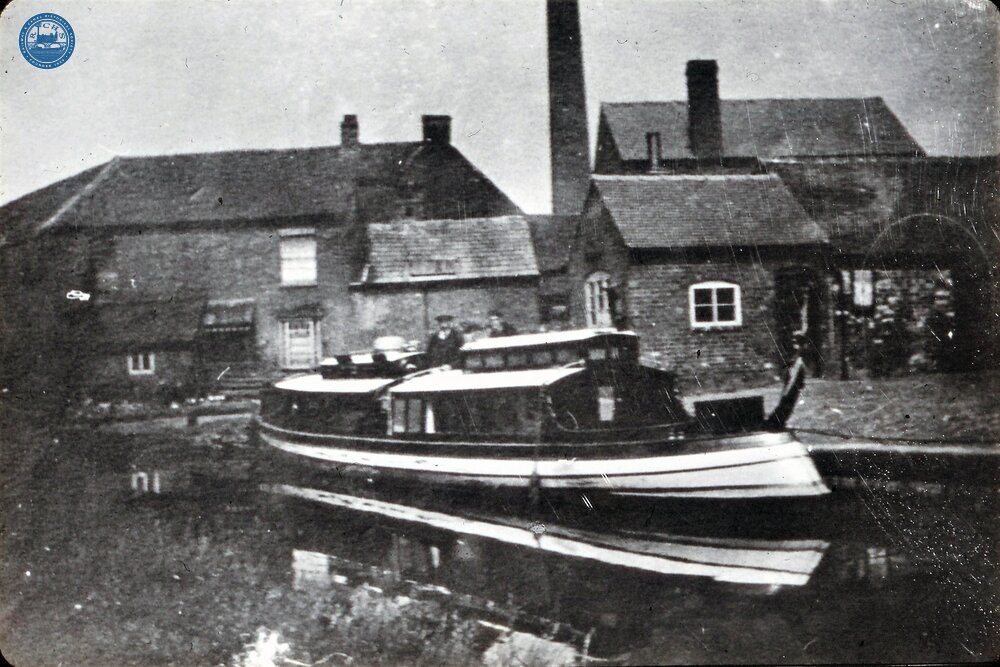 Elegant beaver stern Steam(?) Launch at canal maintenance yard (From Steam on Canals Sub-Collection) 