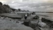 Narrow boat wreck on shoreline near entrance to Lydney Canal