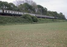 87016 Southbound passenger train in landscape. Muscot (WCML) 20  May 1975. (Ref: 017026)