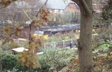 017371 Class 47 47482? hidden by foliage. 89 Byrons Lane, Macclesfield October 1993