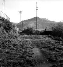 Penydarren Tramroad (Castle Morlais Line).  Pen Yard, Pen-y-Darren. View opposite the Music Hall Inn in High Street looking east. In the background the Castle Morlais line curved very sharply to the left in a hairpin bend to cross the main road into Tramroad Lane.  24th  October 1949 (2)  