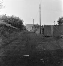 Cwm Clydach valley: tramroad passing the John Player tinplate works at Clydach-on-Tawe, facing north. .Map ref. SN 688 011. 1965 (1)
