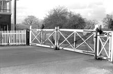 Bramley (BKE @ 46m 41ch) Crossing gates - roadside view from west. Shut for road traffic. (Ref: 325218E  C8_10)