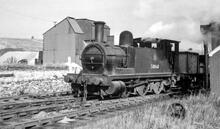 Middleton Top. 2F 0-6-0T No. 58860 is shunting wagons with the sidings and buildings of Redhill Quarry behind.