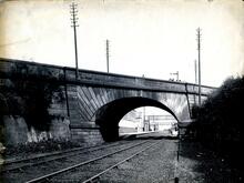 Rainhill, bridge No 71 (DSE @ 8m 67ch). Track level view of west face of bridge, with station beyond. July 1883 (Ref: 030605a)