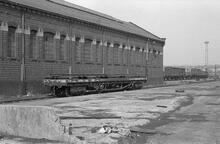 012042  Rugby Goods Shed (LEC1 @ approx 82m 50ch). Northern side with bogie bolster wagon B942449. 8 August 1975 (Ref: 012042)