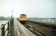 New Holland Pier station (NHP @ 107m 13ch), DMU  E50001/56043 on pier crossover. 27 September 1980
