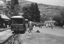  Ffestiniog Railway. Tan-y-Bwlch (RFF @ 7m 35ch). Train at station with observation car no 100 at rear. No locomotive