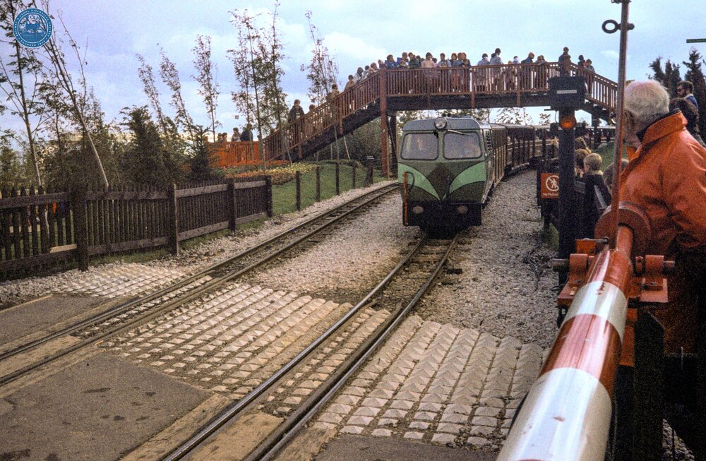 Liverpool 'Garden Festival' railway. R&ER 'Shelagh of Eskdale' on train by Level Crossing near shed. 22 September 1984