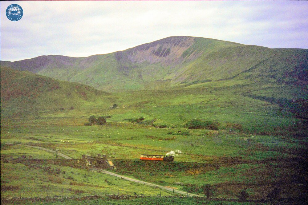 South of Hebron (1m 08ch). Up train approaching bridge over minor road, view from the East. 05 August 1989