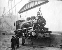 Nasmyth Wilson (works number 1594) standard gauge, 2-8-2 locomotive being loaded aboard ship.