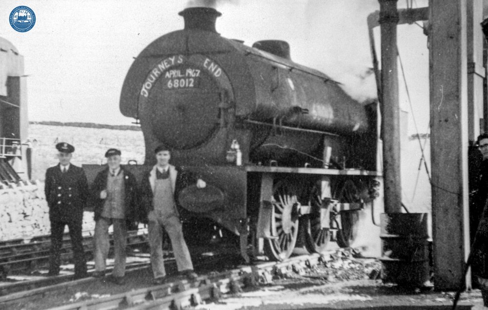 Guard Arthur Millward, Driver Sam Buckley and Fireman Dennis Vallance in front of J94 No.68012 before leaving with the last scheduled train from Middleton Top on the Cromford & High Peak Railway. 21 April 1967