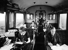 Evacuated office staff working in a GWR Restaurant car converted for office use and stabled at Newbury Racecourse Station 18 October 1939. (Ref: 030721)