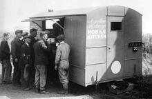 Men working on clearing the bomb damaged Southcoates Lane Bridge in Hull obtaining refreshment from a Mobile Kitchen presented to Britain's railways by the Argentine railways. July 1943. (Ref: 030827)