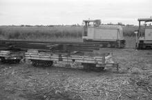 017841E Diesels and bogie wagon.Taken from Free Train. Between Nadi and Lautoka. 3 November 1973