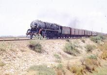 325026E Southern Railway passenger train hauled by 5' 6” gauge, 4-6-2 steam locomotive No. WP7284, north of Madras. 20 April 1974