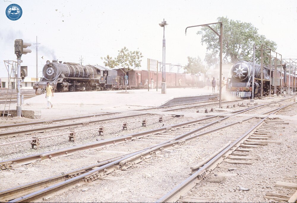325027E Rajamundry, Andhra Pradesh station, with two trains hauled by steam locomotives. 22 April 1974