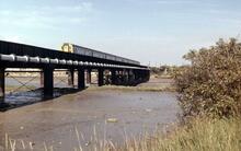 London Victoria - Littlehampton train crossing the River Adur Viaduct, Shoreham-by-Sea (BLI1 @ approx 6m 45ch). 17 August 1974  (Ref: 221401)