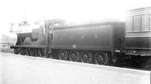 L12 Class number 432.,4-4-0 on a passenger train at Waterloo.  3/4 rear view of tender (Ref: 011885E  ButRob12 )