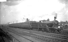 T7 or E10 class 4-2-2-0 double single  on passenger train. Number not known (Ref: 011887E  ButRob14)  