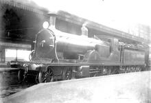 E10 Class 4-2-2-0 double single steam locomotive on passenger train, awaiting departure from Waterloo. number 373. built Nine Elms 901, withdrawn 1926. (Ref: 011905E BuiRob141 )
